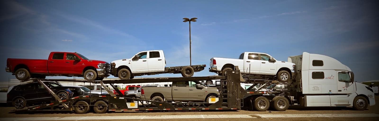 ULTAS truck 028 hauling a load of pickup trucks under a blue sky